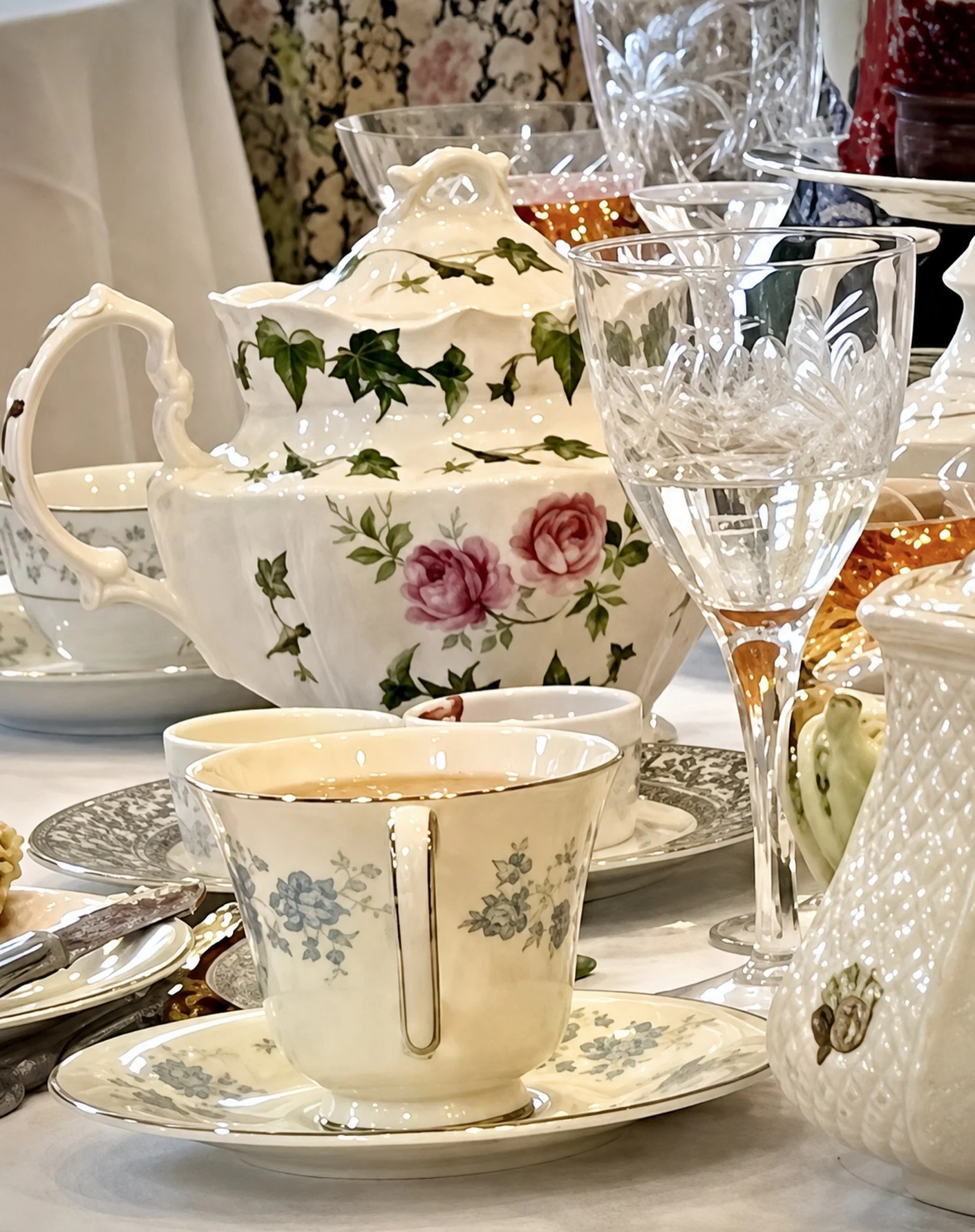 Floral teapot, gilded cup and cut crystal at a Rugby Reserve tea