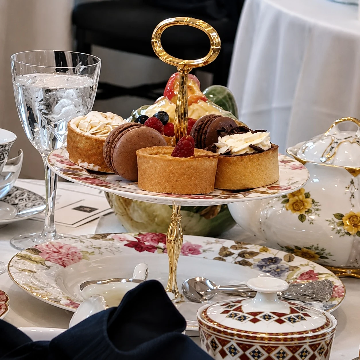 Tiered pastries, sandwiches, patterned china and navy linen at Rugby Reserve